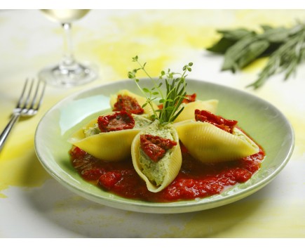 Large shells filled with basil pesto and ricotta cheese