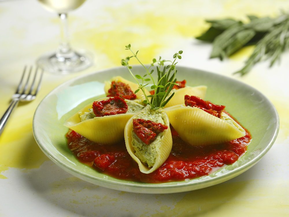 Large shells filled with basil pesto and ricotta cheese